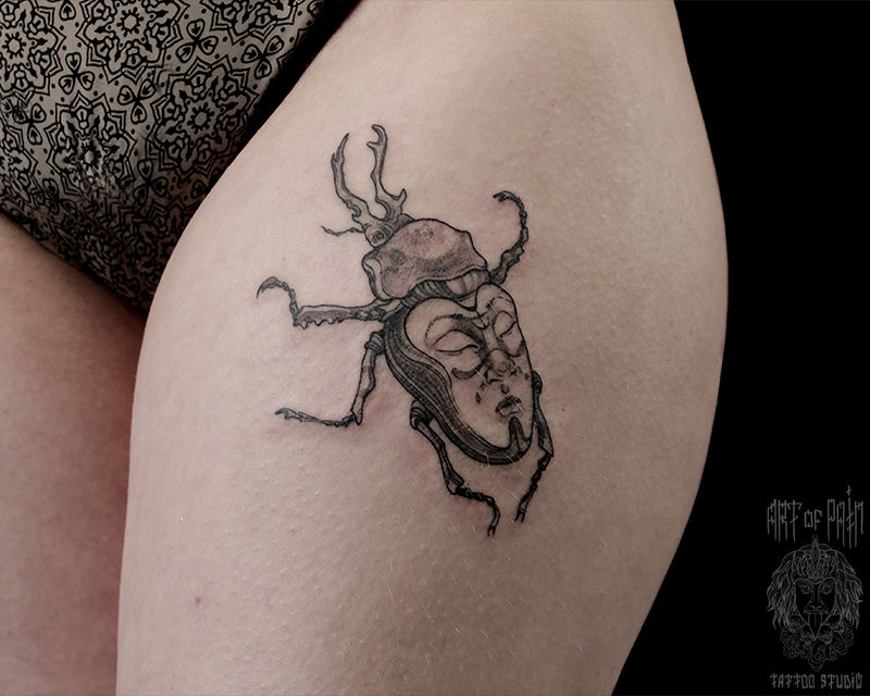Татуировка женская графика на бедре жук и лицо – Мастер тату: Надежда Полякова