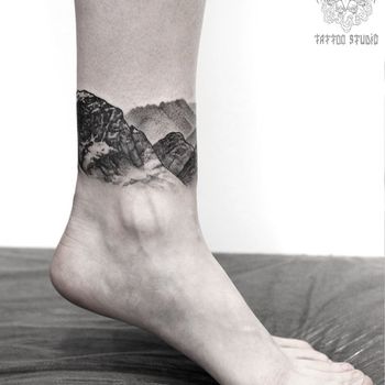 Татуировка женская графика на щиколотке горы